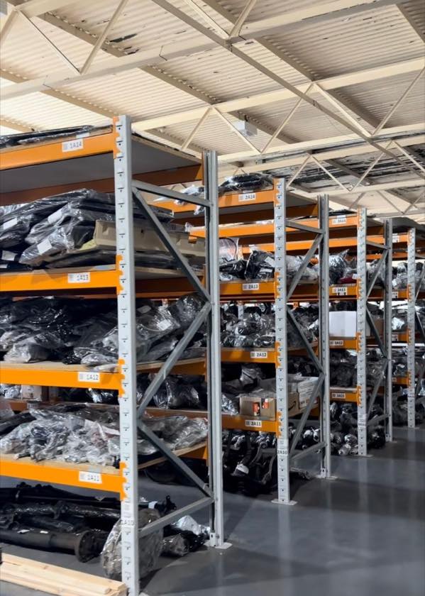 Racking at Partsworth stacked with wrapped, labelled used car parts
